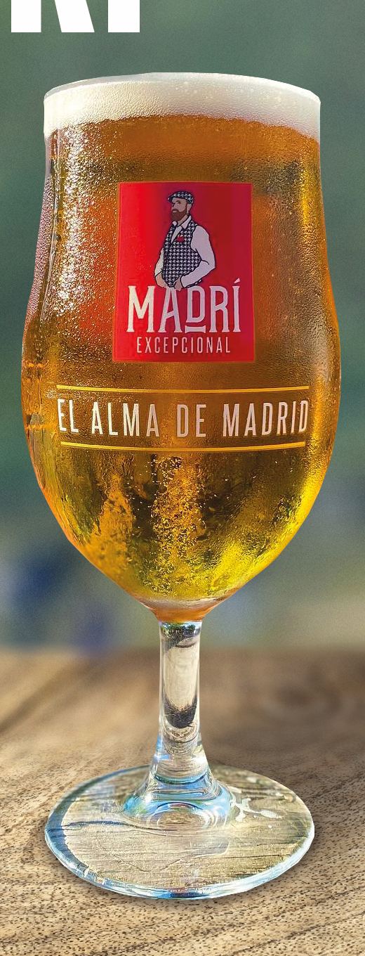 A chilled glass of Madrí lager on a wooden table